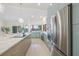 Bright kitchen with stainless steel appliances, marble island, and a view of the waterfront at 5002 E Longboat Blvd, Tampa, FL 33615