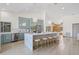 Bright kitchen features a large marble island with seating, modern cabinets, and stylish light fixtures at 5002 E Longboat Blvd, Tampa, FL 33615