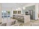 Bright, modern kitchen with a large island, stainless steel appliances, and a waterfront view at 5002 E Longboat Blvd, Tampa, FL 33615