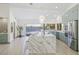 Open kitchen with a large island, modern appliances, and light blue cabinets at 5002 E Longboat Blvd, Tampa, FL 33615