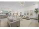 Open-concept living room with modern decor and a view of the kitchen at 5002 E Longboat Blvd, Tampa, FL 33615