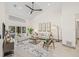 Bright living room with vaulted ceilings, fan, neutral furniture, and water view at 5002 E Longboat Blvd, Tampa, FL 33615