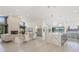 Open-concept living area showcasing a fireplace, marble kitchen island, and view of the water at 5002 E Longboat Blvd, Tampa, FL 33615