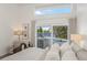 Bright main bedroom with backyard view and access, comfortable seating and neutral colors at 5002 E Longboat Blvd, Tampa, FL 33615