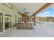 Covered patio features an outdoor kitchen, bar, pool and waterfront views at 5002 E Longboat Blvd, Tampa, FL 33615