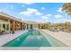 Inviting backyard showcasing a pool, outdoor kitchen, and serene waterfront views at 5002 E Longboat Blvd, Tampa, FL 33615