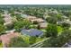 A home with screened pool and fenced yard is nestled within mature trees at 505 Vintage Way, Brandon, FL 33511