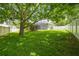 Expansive backyard with lush greenery, white fence, and screened-in patio at 505 Vintage Way, Brandon, FL 33511