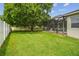 Well-maintained backyard with lush green lawn and partially screened patio at 505 Vintage Way, Brandon, FL 33511