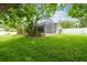 Spacious backyard features lush green grass and a screened in patio at 505 Vintage Way, Brandon, FL 33511