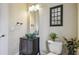 Modern bathroom features a green bowl sink, black vanity, toilet and an illuminated mirror at 505 Vintage Way, Brandon, FL 33511