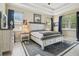 Cozy bedroom featuring a decorative rug, tray ceiling and large picture window at 505 Vintage Way, Brandon, FL 33511