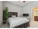 Bright bedroom with ceiling fan, wood floors, and ensuite bathroom at 505 Vintage Way, Brandon, FL 33511
