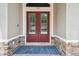 Close-up of the front door with a blue rug and stone accents around the entrance at 505 Vintage Way, Brandon, FL 33511