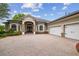 Gorgeous home with a three-car garage and a stylish stone-accented facade at 505 Vintage Way, Brandon, FL 33511