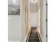 Hallway with white trim, a decorative mirror and a black and white runner at 505 Vintage Way, Brandon, FL 33511