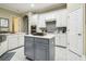 Kitchen with white cabinets, a gray island, stainless steel appliances, and a tiled backsplash at 505 Vintage Way, Brandon, FL 33511