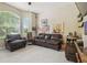 Inviting living room featuring leather furniture, light-colored flooring, and bright, natural light at 505 Vintage Way, Brandon, FL 33511