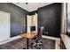 Home office with black walls, desk, leather chair and a door to another room at 505 Vintage Way, Brandon, FL 33511