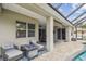 Inviting covered patio with comfortable seating and fire pit, perfect for outdoor relaxation and entertaining at 505 Vintage Way, Brandon, FL 33511