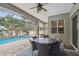A covered patio with outdoor furniture overlooking a screened-in pool area at 505 Vintage Way, Brandon, FL 33511