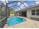 Relaxing pool area with a screened-in enclosure, perfect for swimming and lounging at 505 Vintage Way, Brandon, FL 33511
