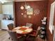 Cozy dining area features a round table, comfortable chairs, and unique wall decor at 5105 Wood St, Zephyrhills, FL 33542