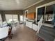 Enclosed porch featuring vinyl siding, a washer/dryer hookup, and seating area at 5105 Wood St, Zephyrhills, FL 33542