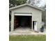 Exterior view of detached garage with open garage door revealing the interior at 5105 Wood St, Zephyrhills, FL 33542