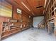 Spacious garage interior featuring storage shelving and a staircase leading to a loft at 5105 Wood St, Zephyrhills, FL 33542