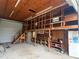 Spacious garage interior featuring a small loft and storage shelving at 5105 Wood St, Zephyrhills, FL 33542