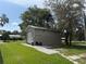 Exterior view of a large detached garage on a large lot at 5105 Wood St, Zephyrhills, FL 33542