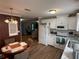 Bright kitchen with white cabinets, stainless appliances, and an adjacent dining area at 5105 Wood St, Zephyrhills, FL 33542