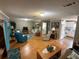 Inviting living room with wood flooring, a variety of seating, and a view of the adjacent kitchen at 5105 Wood St, Zephyrhills, FL 33542