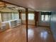 Bright living room with wood floors, built-in bookshelves, and plenty of natural light at 5105 Wood St, Zephyrhills, FL 33542
