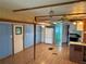 Open-concept living area featuring wood floors, blue accent walls, and access to the kitchen at 5105 Wood St, Zephyrhills, FL 33542