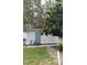 Side view of outdoor shed, showing door, siding, and a bike at 5105 Wood St, Zephyrhills, FL 33542