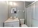 Cozy bathroom with a shower, vanity, and a gray and white color scheme at 5210 Dr Martin Luther King Jr St N St, St Petersburg, FL 33703