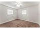 Cozy bedroom with carpet, ceiling fan, and natural light from two windows at 5210 Dr Martin Luther King Jr St N St, St Petersburg, FL 33703