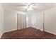 Cozy bedroom featuring neutral paint, ceiling fan, and large window with curtains at 5210 Dr Martin Luther King Jr St N St, St Petersburg, FL 33703