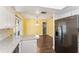 View of dining area with yellow walls, adjacent kitchen, and sliding glass doors at 5210 Dr Martin Luther King Jr St N St, St Petersburg, FL 33703