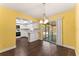 Inviting dining area with hardwood floors, seamlessly connecting to a modern kitchen and screened-in patio at 5210 Dr Martin Luther King Jr St N St, St Petersburg, FL 33703