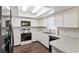 Well-lit kitchen with white cabinets, stainless steel appliances, and mosaic tile backsplash at 5210 Dr Martin Luther King Jr St N St, St Petersburg, FL 33703