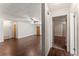 Spacious living room featuring hardwood floors, ceiling fan, and hallway access at 5210 Dr Martin Luther King Jr St N St, St Petersburg, FL 33703
