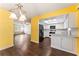 Bright, open-concept space with hardwood floors, combining the living, dining, and kitchen areas for modern living at 5210 Dr Martin Luther King Jr St N St, St Petersburg, FL 33703