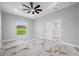 Bright bedroom with large windows and a tray ceiling at 5317 Lydia Ct, Spring Hill, FL 34608