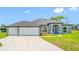 Charming single-story home featuring a three-car garage, well-maintained landscaping, and a covered front entry at 5317 Lydia Ct, Spring Hill, FL 34608