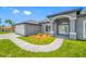 Charming single-story home with a well-manicured lawn, inviting entryway, and attached garage at 5317 Lydia Ct, Spring Hill, FL 34608