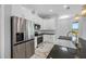 Modern kitchen featuring stainless steel appliances, white cabinetry, and a contrasting dark countertop at 5317 Lydia Ct, Spring Hill, FL 34608