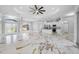 Open-concept living area with sleek, modern finishes, tray ceiling, and gorgeous marble floors at 5317 Lydia Ct, Spring Hill, FL 34608